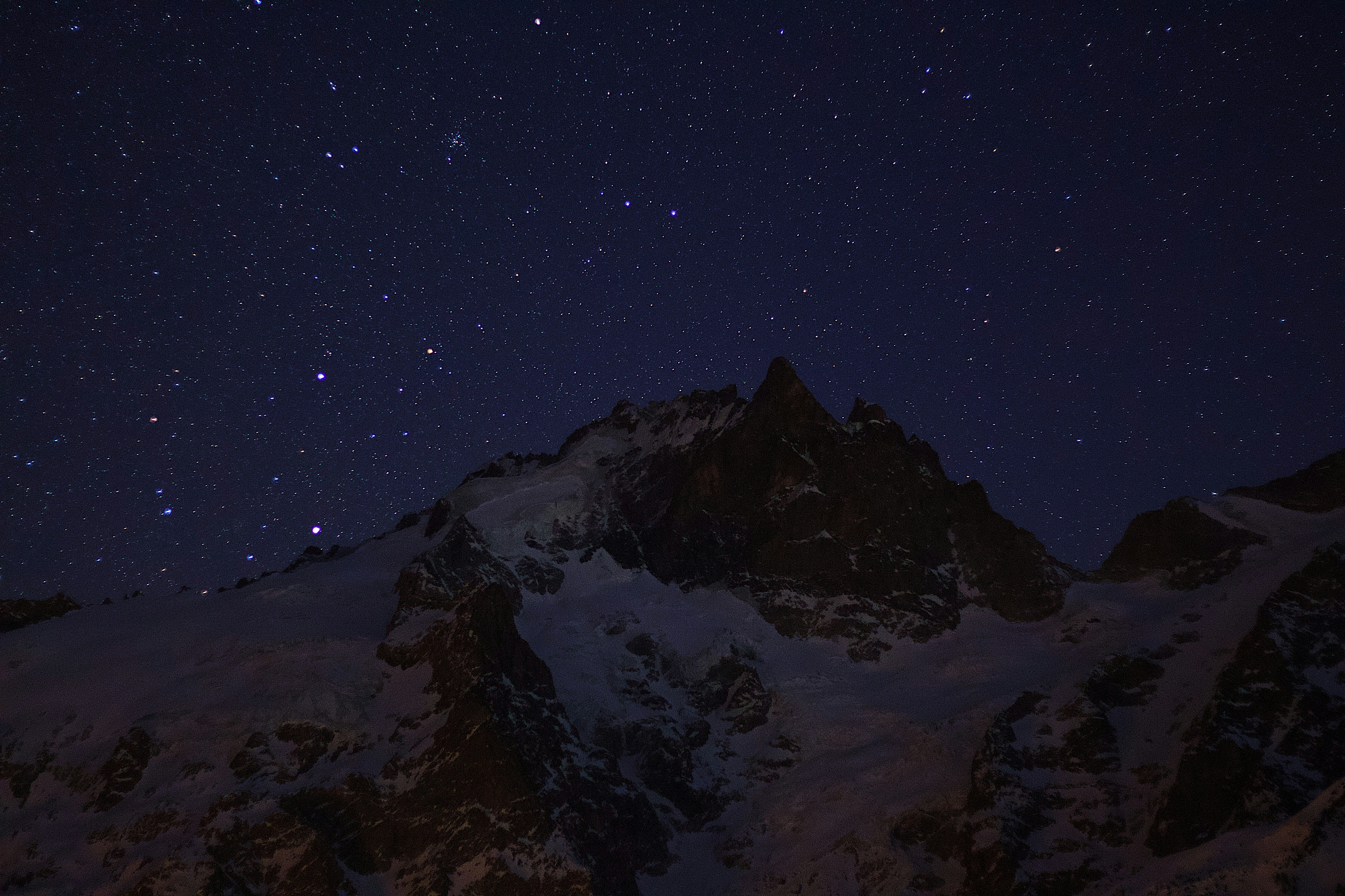 snow covered mountain under blue sky